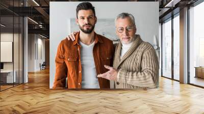 senior father gesturing near handsome bearded son Wall mural