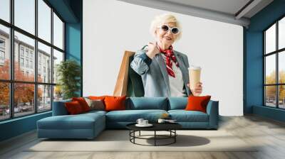 senior woman with shopping bags and coffee Wall mural