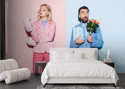 serious woman with boxing gloves and scared man with gift and bouquet on pink and blue background Wall mural