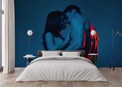 sexy couple kissing while standing on blue Wall mural