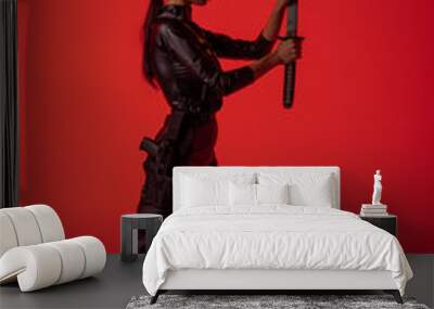 side view of futuristic african american woman in glasses with sword on red background Wall mural