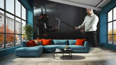 side view of man with katana standing in fornt of samurai while he using laptop Wall mural