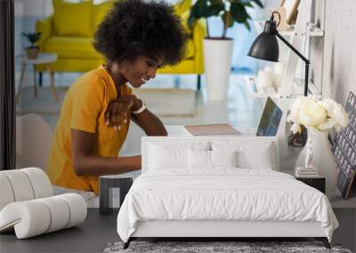 side view of smiling african american female freelancer working at home Wall mural