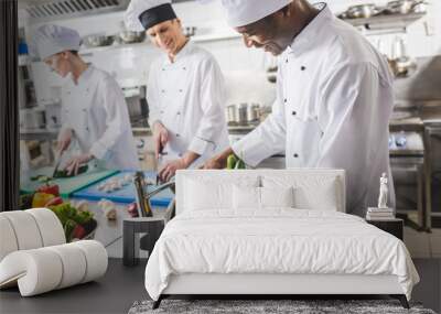 smiling african american chef washing vegetables at restaurant kitchen Wall mural