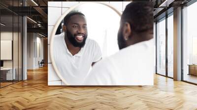 smiling afro-american man looking in mirror Wall mural