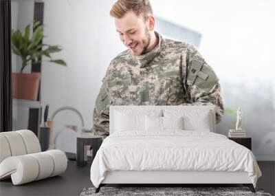 smiling army soldier cooking on pan in kitchen Wall mural