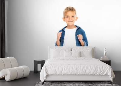 Smiling boy showing yeah gesture isolated on white Wall mural