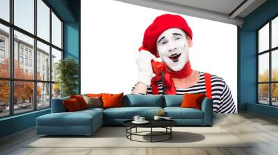 smiling mime talking by stationary telephone isolated on white Wall mural