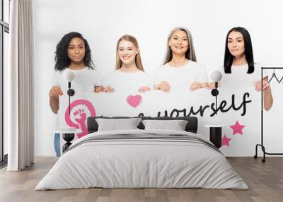 smiling multicultural women holding poster with love yourself lettering isolated on white Wall mural