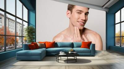 smiling sexy man with muscular torso touching skin isolated on grey Wall mural