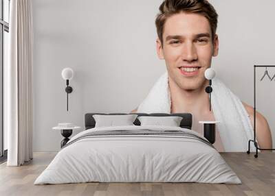 smiling sexy young naked man with cotton towel isolated on grey Wall mural