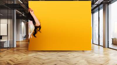 smiling stylish summer brunette girl with shopping bags on yellow background, panoramic shot Wall mural