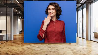 smiling teacher showing thank you gesture on sign language isolated on blue. Wall mural