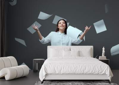 smiling young businesswoman throwing papers isolated on grey Wall mural