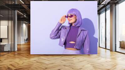 smiling young woman dressed in doll style on violet colorful background Wall mural