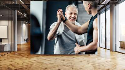 sportsman giving highfive to trainer Wall mural