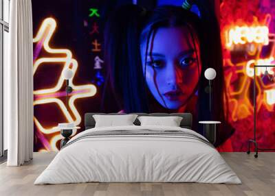 stylish young asian woman looking at camera near neon lighting outside, banner Wall mural