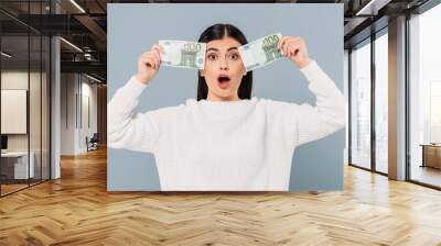 surprised pretty girl in white sweater holding euro banknotes isolated on grey Wall mural