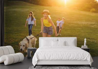 teenagers with dog walking in park Wall mural