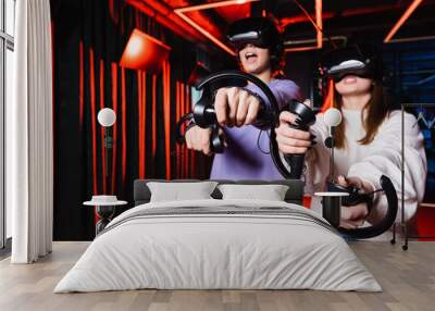 thrilled teenage gamers in vr headsets having fun in play zone Wall mural