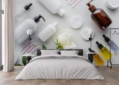 top view of bottles of cream, cosmetic pads and rose on white surface, beauty concept Wall mural