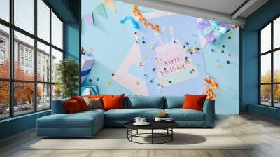 top view of colorful confetti near gift boxes and birthday greeting cards on blue background Wall mural