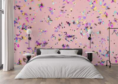 Top view of colorful confetti on pink party background Wall mural