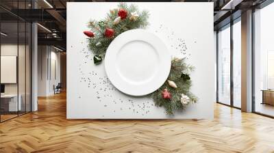 Top view of festive Christmas table setting on white background with decorated pine branch, plate and confetti Wall mural