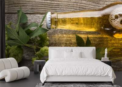 top view of fresh beer in bottle with green hop on wooden table, panoramic shot Wall mural