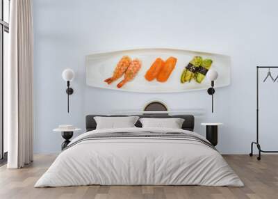 top view of gourmet sushi, soy sauce and chopsticks isolated on white Wall mural