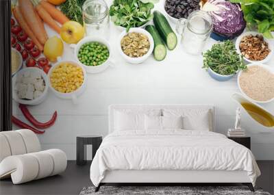 top view of organic fruits and vegetables near glass jars on wooden white table with copy space Wall mural