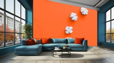 top view of question mark shape with white puzzle pieces on orange Wall mural