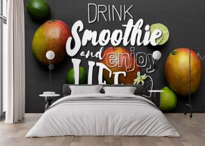 top view of ripe limes and mango on black background, drink smoothie and enjoy life illustration Wall mural