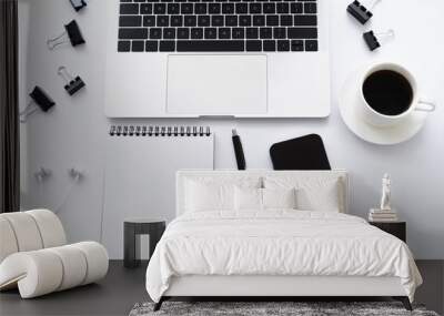 top view of smartphone with blank screen near laptop, earphones and stationery on white. Wall mural