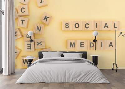 top view of social media lettering with wooden cubes on yellow background Wall mural