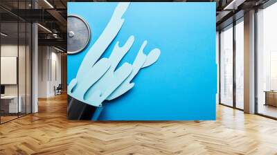 top view of spilled paper cut blue paint near metal can and cap Wall mural