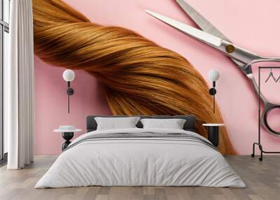 Top view of twisted brown hair with scissors on pink background Wall mural