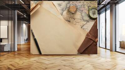 top view of vintage blank paper with fountain pen near compass and leather notepad on map background Wall mural