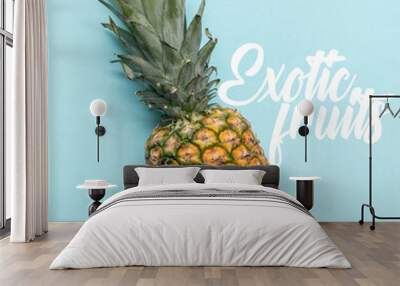 top view of whole ripe tropical pineapple on blue background with exotic fruits illustration Wall mural