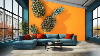 top view pineapples with shadows an on orange background and copy space Wall mural