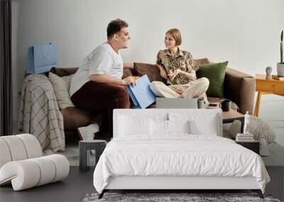 Two friends share laughter and conversation in a stylish living room. Wall mural