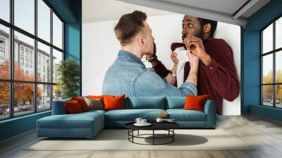 two multicultural students fighting in corridor in college Wall mural