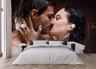 Wet couple kissing near water splashes with closed eyes on dark background Wall mural