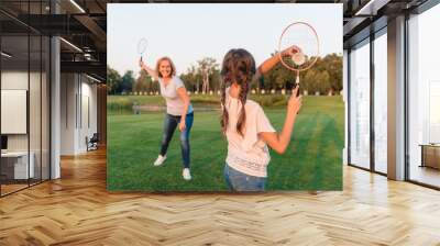 woman and granddaughter playing badminton Wall mural