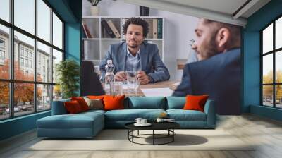 young african american businessman sitting in meeting room near multicultural colleagues Wall mural