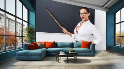 young attractive teacher pointing at chalkboard Wall mural