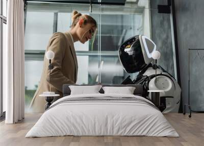 young businesswoman operating robot in office Wall mural