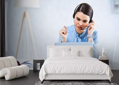 young call center operator working near laptop in office Wall mural