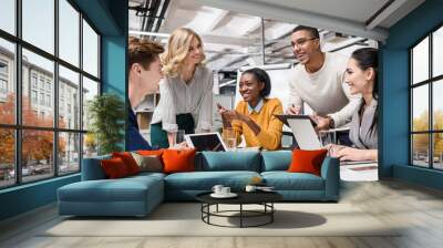 young happy managers working together at conference hall in modern office Wall mural