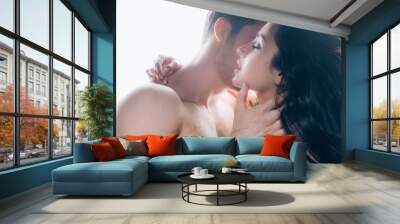 young man passionately kissing nude woman with closed eyes isolated on white Wall mural